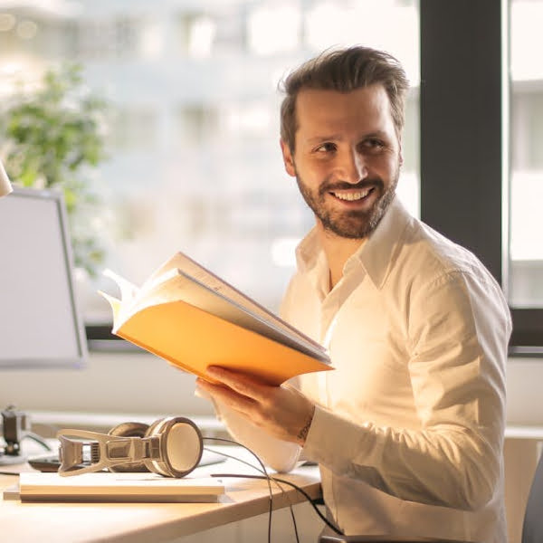 The Right Cloud Backup Choice for UK SMEs Man smiling while working in an office